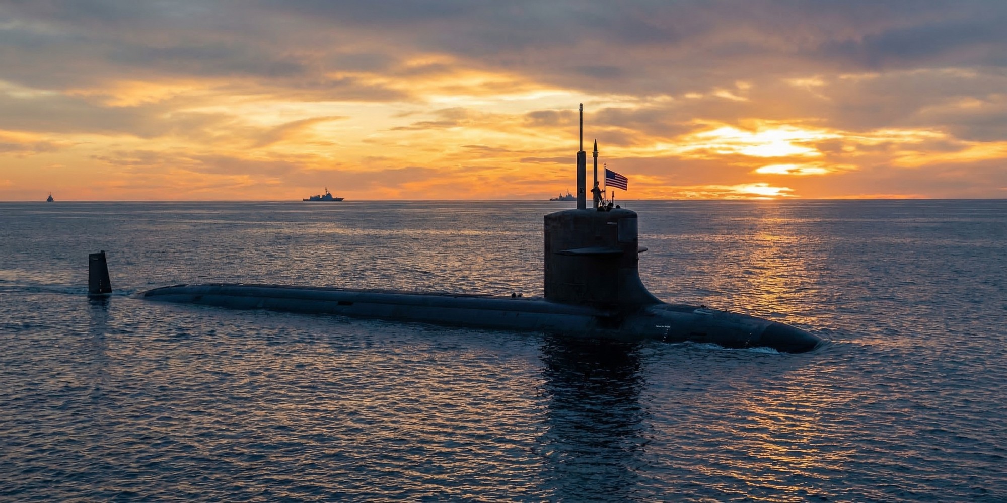 Virginia-class nuclear attack submarine surfaced in Pacific Ocean waters at dusk, American naval ensign flying, dramatic golden sunset sky