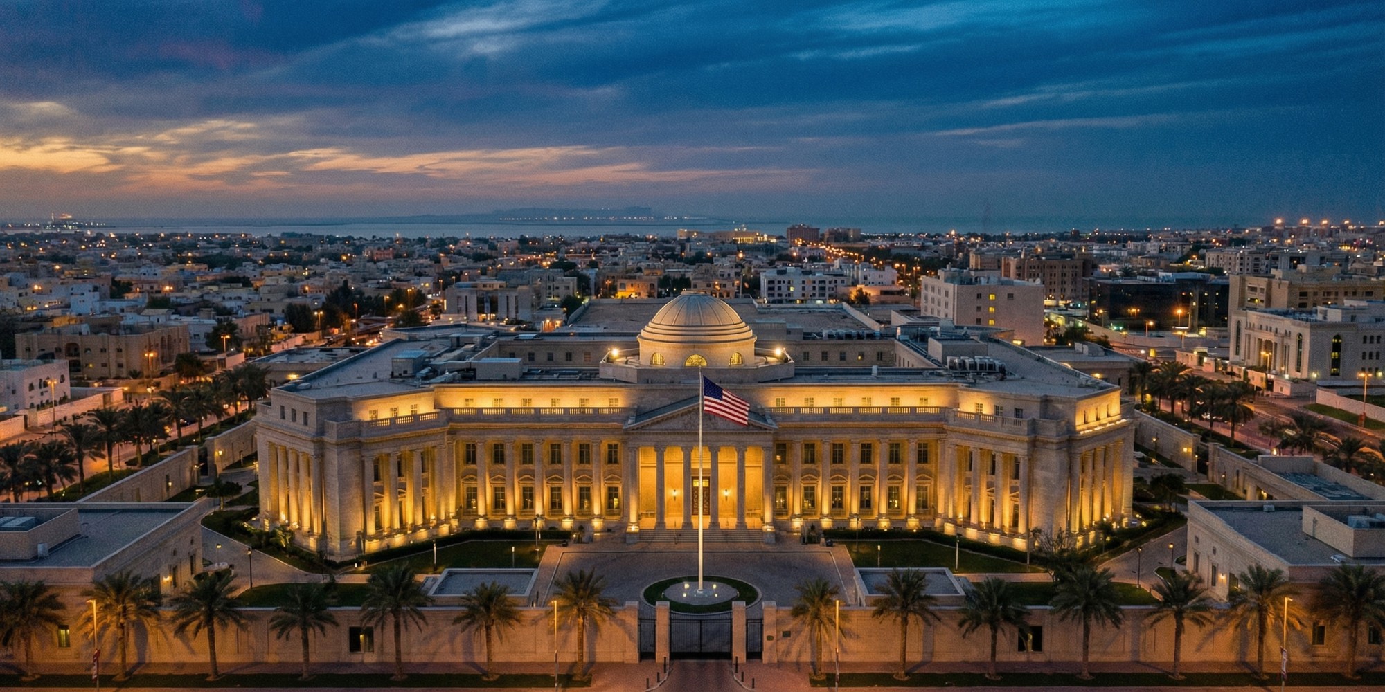 Aerial view of an American embassy complex in a Middle Eastern diplomatic district at dusk
