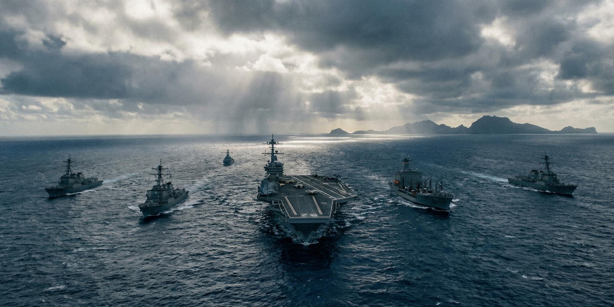 U.S. carrier strike group underway in the Pacific Ocean, aerial view of aircraft carrier and escort vessels, dramatic overcast light, no crew visible