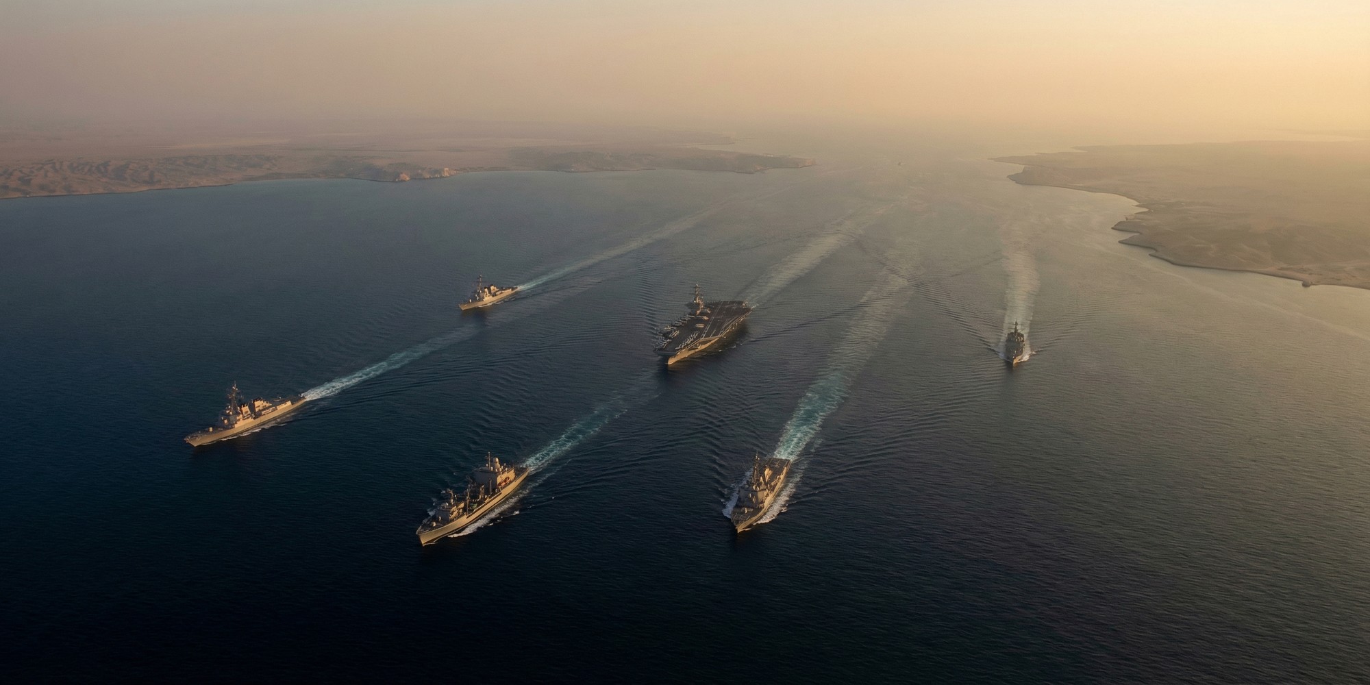 Aerial view of the Strait of Hormuz with U.S. Navy carrier strike group in formation, Persian Gulf maritime chokepoint